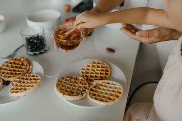 Mother and daughter preparing food in kitchen