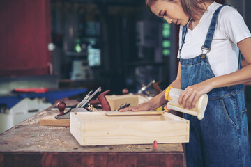 In a bustling carpenter's shop, a young woman craftsman expertly navigates her workshop, merging traditional woodwork skills with modern equipment to create hand-made furniture