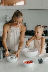 Mother and daughter preparing food in kitchen
