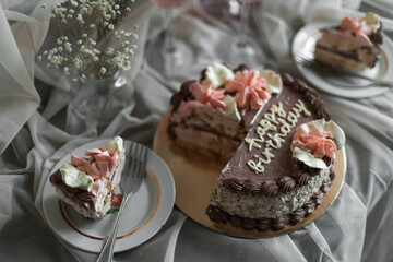 a chocolate cake with pink flowers on top of it