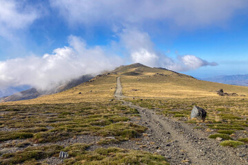 Cloudy over mountains on hiking trail to Mulhacen peak, Sierra Nevada National park, Andalusia, Spain