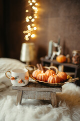 Handmade soy candle in the shape of a tangerine on a light background
