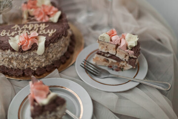 a chocolate cake with pink flowers on top of it