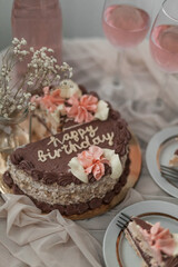 a chocolate cake with pink flowers on top of it