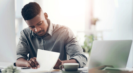 Laptop, notebook and writing with business black man at desk in office for planning or review. Computer, journal and notes with professional employee in workplace for information or research