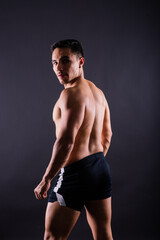 Fototapeta premium Muscular and torso of young man having abs, bicep and chest. Male hunk with athletic body.
