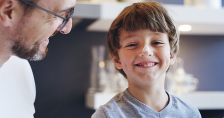 Obraz premium Child, happy and flour in kitchen with father, playful and fun cooking breakfast on weekend. Young boy, portrait and man in home for bonding, relationship development and messy morning with smile