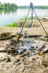 Big log fire by the riverside in spring and summer