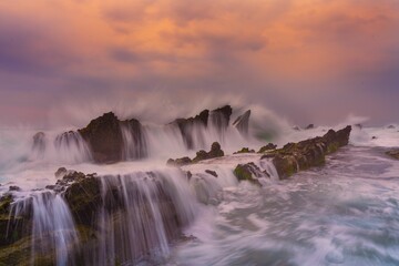 Dramatic seascape with crashing waves at sunset