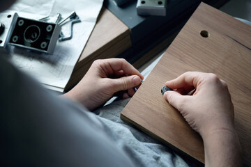 teenager assembles furniture according to instructions