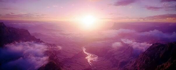 Obraz premium Breathtaking Sunrise Over Vast Mountain Landscape with Clouds and River Streaming Through the Valley in Soft Pastel Hues of Pink and Purple Light