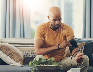 Man, home and monitor blood pressure for test, health or wellness of pulse on sofa. African person,...