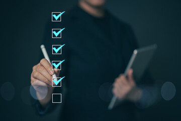 Business performance checklist concept Young business woman using laptop surveys online checklist...
