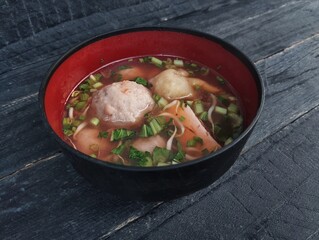 Bakso or meat ball, Indonesian food in bowl on the wooden table with high angle view setup 