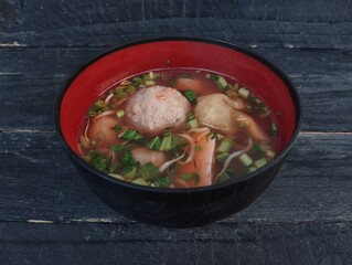 Bakso or meat ball, Indonesian food in bowl on the wooden table with high angle view setup 