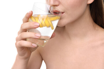 Woman drinking water with lemon on white background, closeup