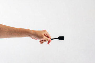 Black ice cream spoon in hand on white background
