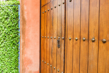 Close up of old Key in wooden door at home, Brown Wood Front Door with Ornate Brass Skeleton Key,copy space..