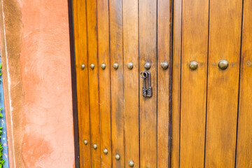 Close up of old Key in wooden door at home, Brown Wood Front Door with Ornate Brass Skeleton Key,copy space..