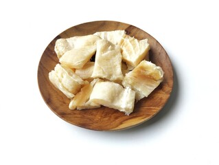 Dry salted fish on wooden plate isolated on white background with high angle view setup 