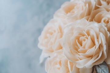 Close-up of a bouquet of candles resembling a bouquet of roses on a neutral background
