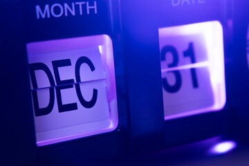 December 31st on flip calendar clock in purple light