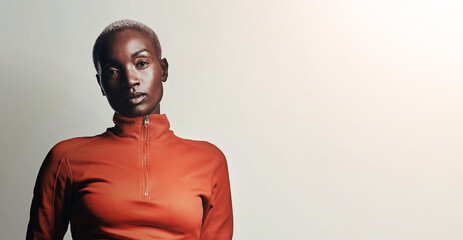Sportswear, portrait and black woman in studio with confidence, mockup and fitness space. Gym, proud athlete or African girl with serious face with sports, commitment and banner with white background