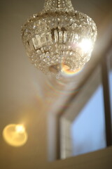 Texture, pattern, background. light crystal chandelier with blurred focus. Glamour background with copy space.