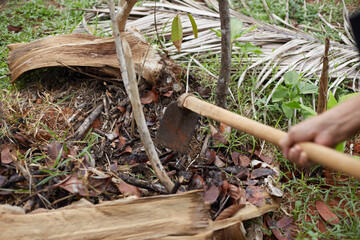 A man hand is digging a hole in the ground for planting