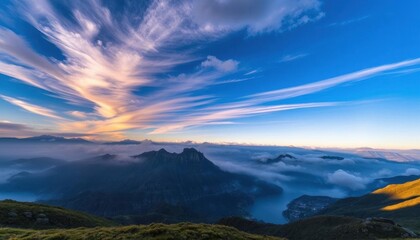 Fototapeta premium a view of a mountain range with clouds and mountains in the background