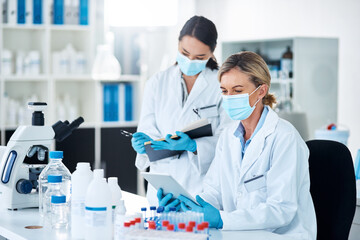 Women, scientist and discussion in lab with tablet, notebook and review for experiment results at...