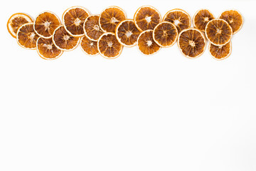 Flat lay Christmas background with dry oranges on white background