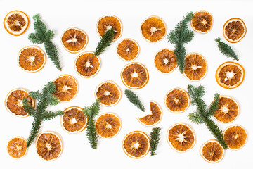 Flat lay Christmas background with dry oranges and fir tree branches on white