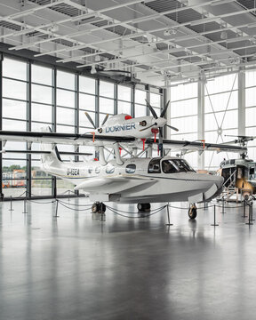 White amphibious aircraft in glass hangar. High wing seaplane Dornier CD-2 Seastar. Friedrichshafen, Germany - September 25 2019.