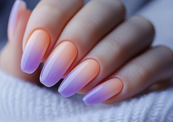 Beautiful ombre nails with gradient shades transitioning from soft peach to elegant purple, perfect for fashion and beauty concepts