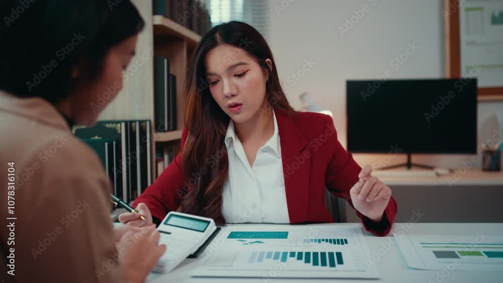 Poster two businesswomen collaborate in an office, analyzing financial reports and using a calculator to as