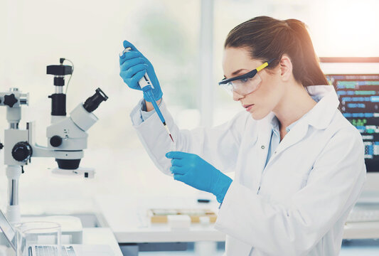 Woman, scientist and syringe in lab with blood sample, tube or process with study for virus dna. Person, liquid and goggles for safety with chemical, test and medical research for vaccine development