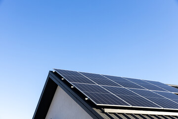 Modern house with solar panels stand-alone photovoltaic plant system on household metal sheet...