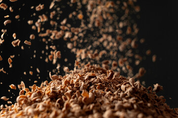 Shredded natural organic chocolate pour on black background