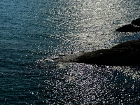 Sea sparkling water and coastal rocks aerial view