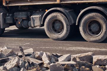 Heavy construction machines and truck outdoors for public street reconstruction.