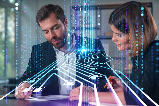 Business professionals discussing technology with digital circuit overlay and binary code.