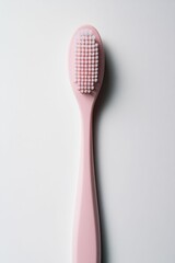 Pink face brush on white background.