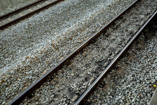 View of a train tracks on ballast gravel and railway sleeper wood