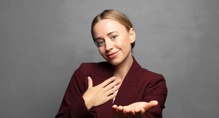 feeling happy and in love, smiling with one hand next to heart and the other stretched up front