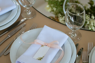 Empty Wedding Reception Hall Table Setting With glasses and Plates