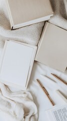 A flat lay of stationery and books, shot from above, close-up, with a minimal aesthetic, muted tones