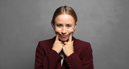 smiling confidently pointing to own fake smile
