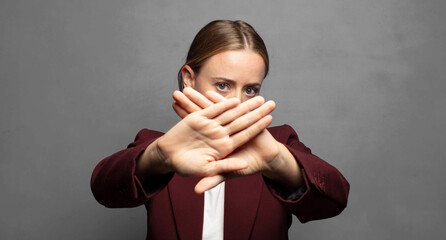 covering face with hand and putting other hand up front to stop camera, refusing photos or pictures
