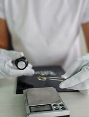 Selection and sorting of diamonds using special device for quality control. Many diamonds, tweezers...